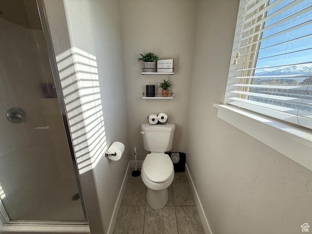 9104 N Cornwall Way E, Eagle Mountain, UT 84005 - full bathroom with a stall shower, baseboards, tile patterned flooring, and toilet