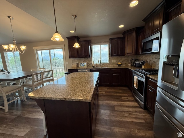 9104 N Cornwall Way E, Eagle Mountain, UT 84005 - kitchen with stainless steel appliances, a sink, dark brown cabinets, tasteful backsplash, and recessed lighting
