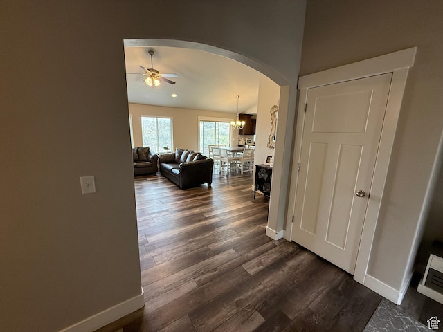 9104 N Cornwall Way E, Eagle Mountain, UT 84005 - hall with arched walkways, baseboards, dark wood-style flooring, and a chandelier