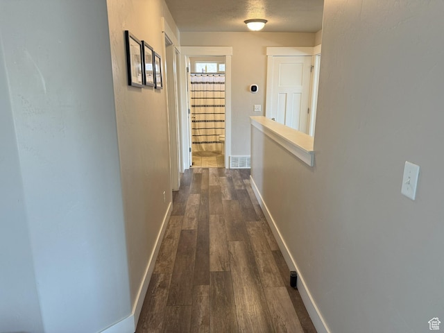 9104 N Cornwall Way E, Eagle Mountain, UT 84005 - corridor with dark wood-style flooring and baseboards
