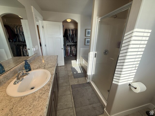 9104 N Cornwall Way E, Eagle Mountain, UT 84005 - full bathroom featuring a shower stall, vanity, tile patterned floors, and a spacious closet