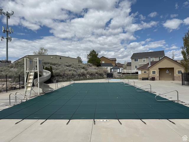 9104 N Cornwall Way E, Eagle Mountain, UT 84005 - community pool with fence, a water slide, and a patio