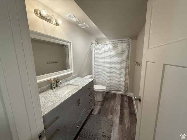 9104 N Cornwall Way E, Eagle Mountain, UT 84005 - bathroom featuring wood finished floors, toilet, vanity, and a shower with shower curtain