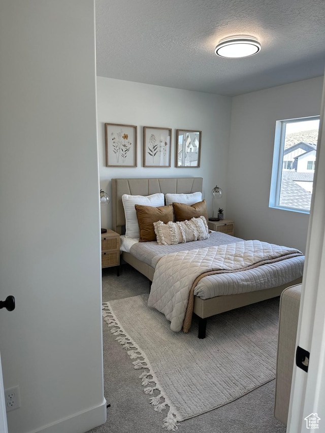 7877 Walnut Dr Unit 303, Eagle Mountain, UT 84005 - carpeted bedroom featuring a textured ceiling