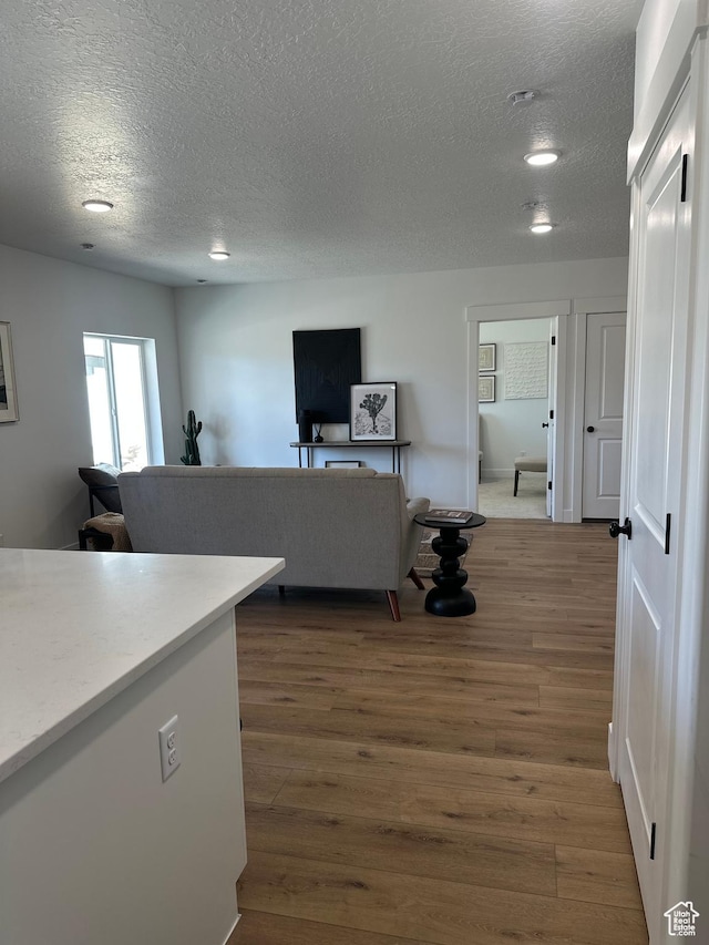 7877 Walnut Dr Unit 303, Eagle Mountain, UT 84005 - interior space featuring wood finished floors, a textured ceiling, and recessed lighting