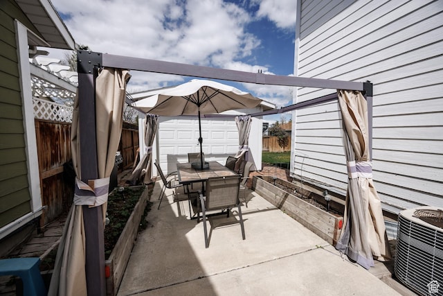 view of patio / terrace with a storage shed, outdoor dining space, a fenced backyard, and central AC unit