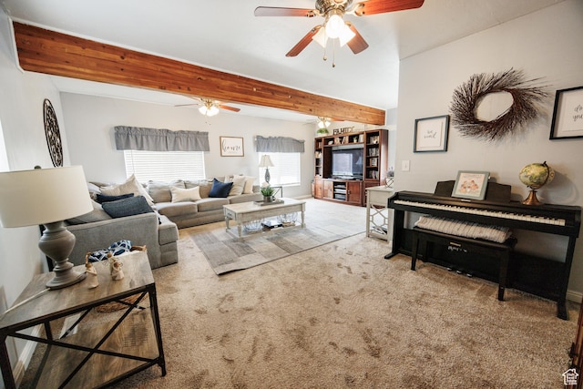 living room with beamed ceiling, carpet floors, and a ceiling fan