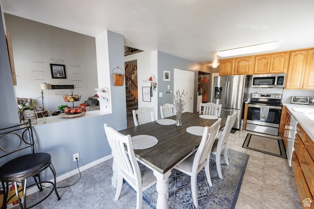 dining space featuring stairway and a toaster