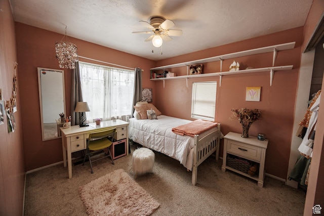 carpeted bedroom featuring ceiling fan and baseboards