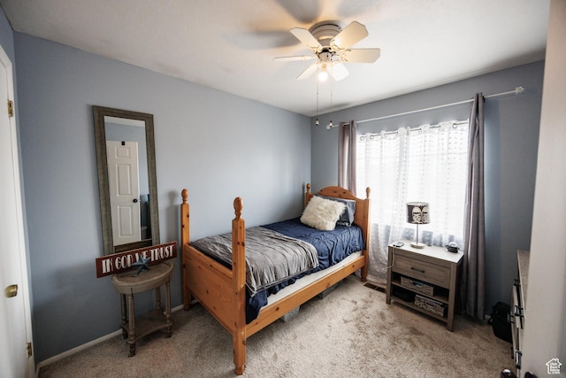 bedroom featuring a ceiling fan and light colored carpet