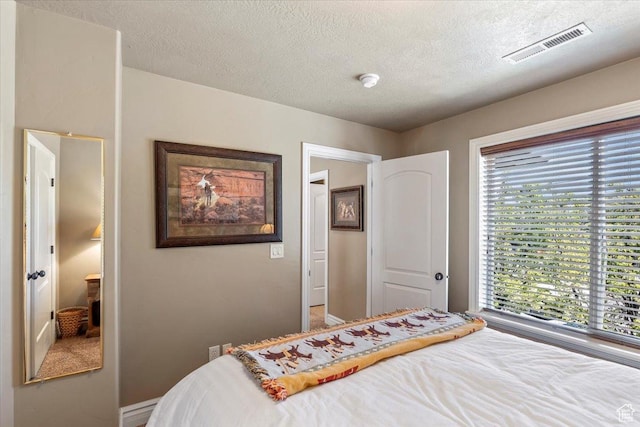6109 S Vine Bend Ln, Murray, UT 84121 - bedroom featuring baseboards, visible vents, a textured ceiling, and multiple windows