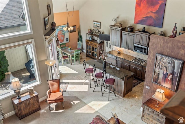 6109 S Vine Bend Ln, Murray, UT 84121 - interior space featuring a chandelier, high vaulted ceiling, and baseboards