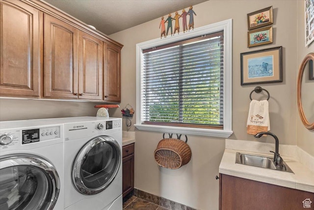 6109 S Vine Bend Ln, Murray, UT 84121 - washroom featuring a sink, dark tile patterned floors, baseboards, washer and dryer, and cabinet space