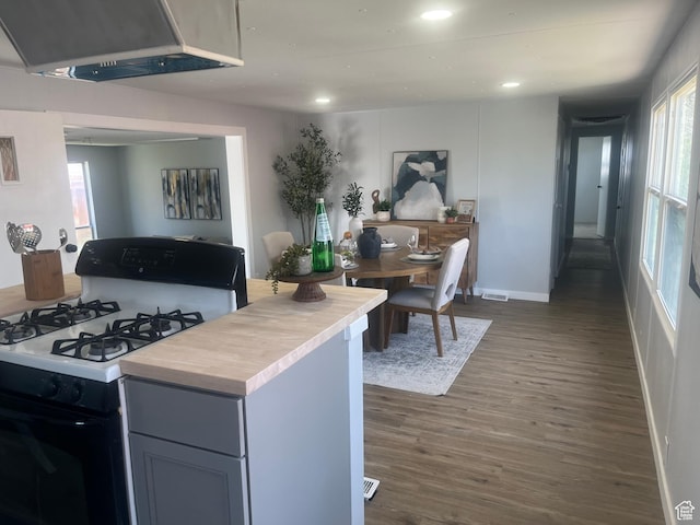 85 E 100 N, Redmond, UT 84652 - kitchen with range with gas cooktop, dark wood-style flooring, light countertops, and exhaust hood