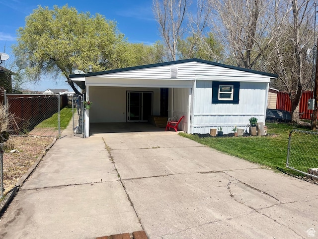 85 E 100 N, Redmond, UT 84652 - view of front of home featuring concrete driveway, fence, a carport, and a front yard