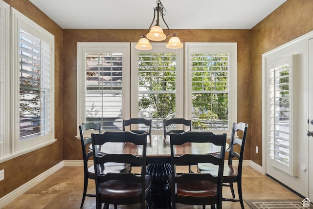 dining room featuring baseboards and light tile patterned flooring
