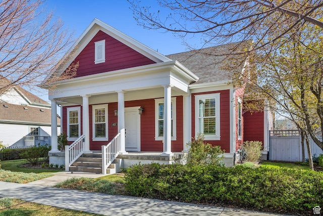 view of front of house with a porch and fence