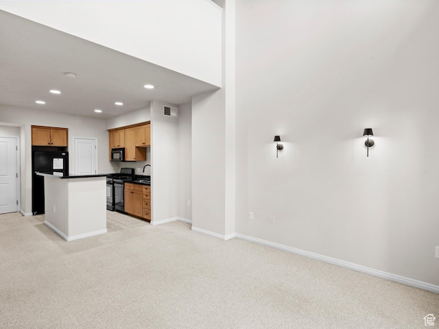 5 S 500 W Unit 311, Salt Lake City, UT 84101 - kitchen with dark countertops, black appliances, light colored carpet, visible vents, and recessed lighting