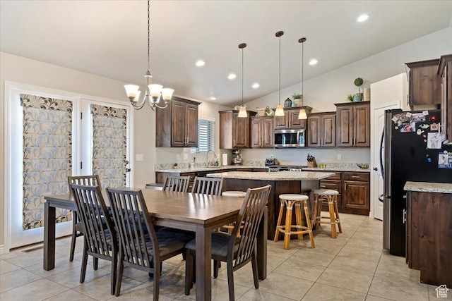 dining space featuring lofted ceiling, an inviting chandelier, recessed lighting, and light tile patterned floors