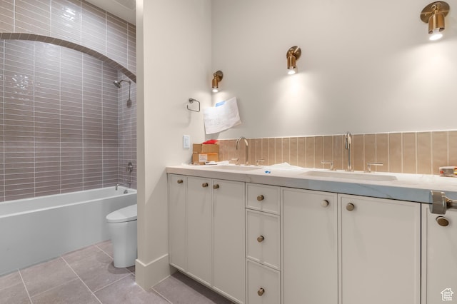 bathroom featuring toilet, shower / bathtub combination, a sink, and double vanity