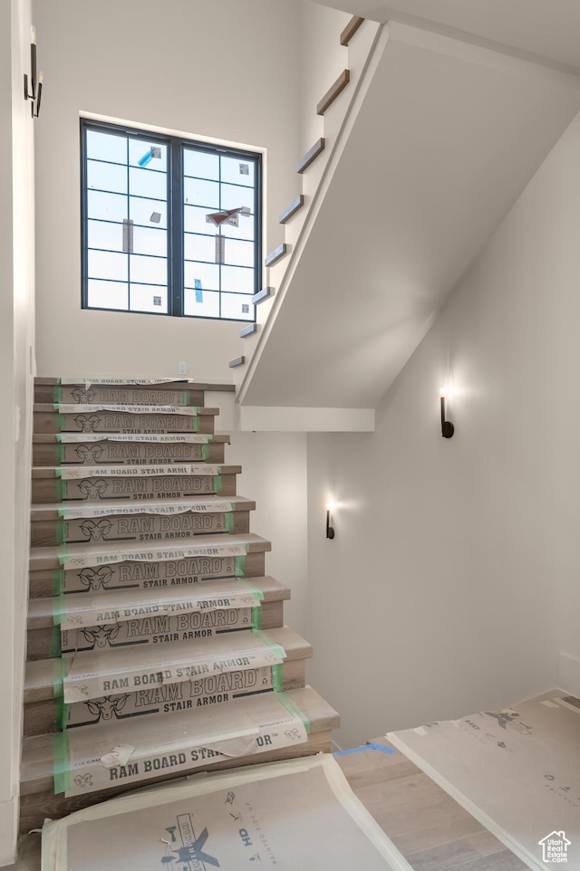 stairway featuring wood finished floors and baseboards