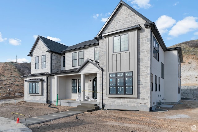 view of front of house featuring a porch and stone siding