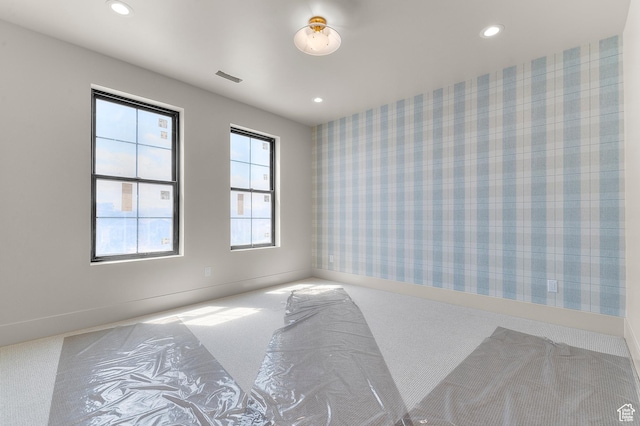 unfurnished room with recessed lighting, wallpapered walls, carpet floors, and baseboards