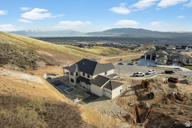 birds eye view of property featuring a mountain view