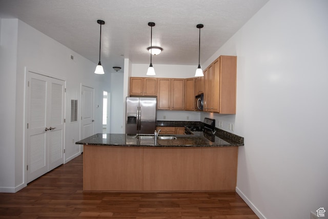 2150 S Main St Unit 514, Salt Lake City, UT 84115 - kitchen featuring a peninsula, dark wood-style floors, a sink, dark stone counters, and appliances with stainless steel finishes