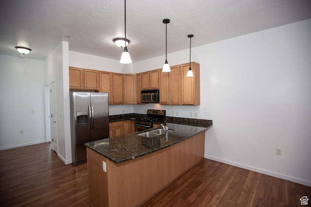 2150 S Main St Unit 514, Salt Lake City, UT 84115 - kitchen featuring stainless steel appliances, a peninsula, a sink, and dark wood finished floors