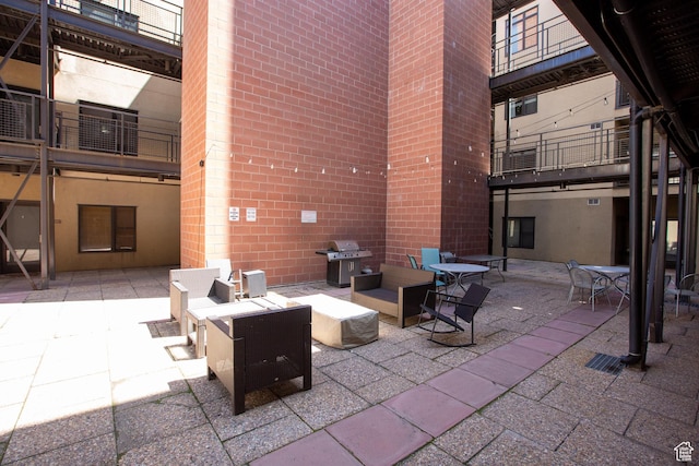 2150 S Main St Unit 514, Salt Lake City, UT 84115 - view of patio / terrace featuring a fire pit, a balcony, and a grill