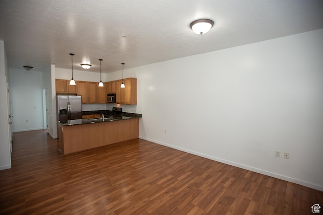 2150 S Main St Unit 514, Salt Lake City, UT 84115 - kitchen featuring a peninsula, dark wood-style floors, dark countertops, baseboards, and stainless steel refrigerator with ice dispenser