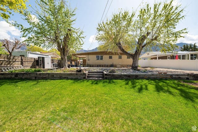 2005 N 500 E, North Ogden, UT 84414 - view of yard with a storage shed, an outbuilding, a fenced backyard, and a mountain view