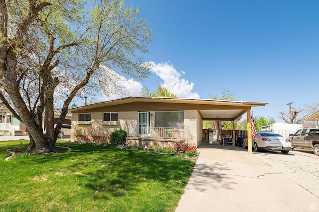 2005 N 500 E, North Ogden, UT 84414 - view of front of property featuring concrete driveway, brick siding, an attached carport, and a front yard