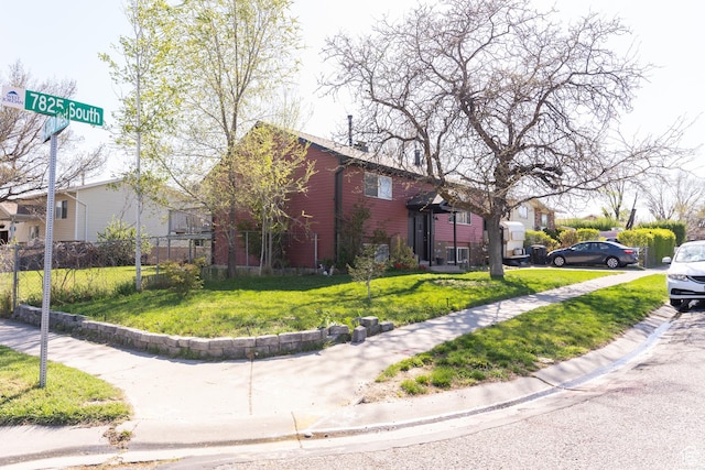 view of home's exterior featuring fence and a yard