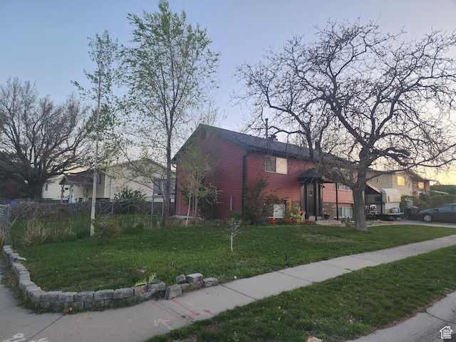 view of front of house with a front lawn and fence