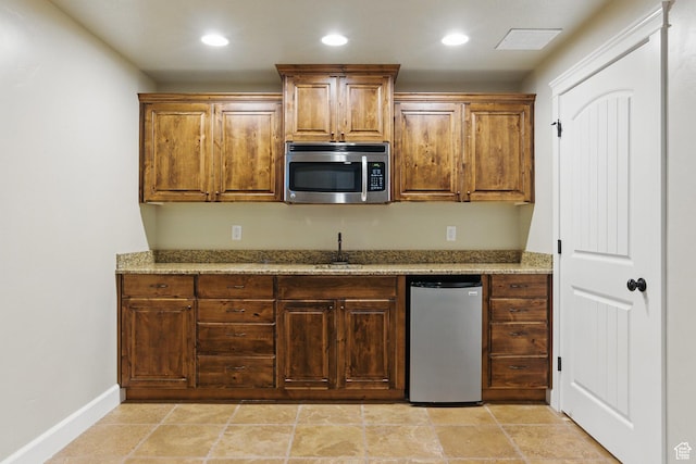 1247 N Baycrest Dr, Saratoga Springs, UT 84045 - kitchen featuring refrigerator, a sink, stainless steel microwave, light stone countertops, and recessed lighting