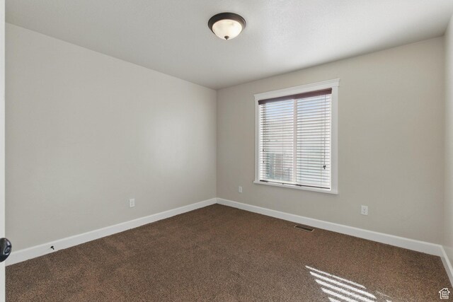 1247 N Baycrest Dr, Saratoga Springs, UT 84045 - spare room featuring baseboards, dark colored carpet, and visible vents