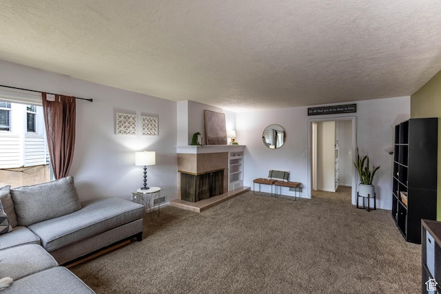 1431 Capitol St, Ogden, UT 84401 - carpeted living room with visible vents, a tiled fireplace, baseboards, and a textured ceiling