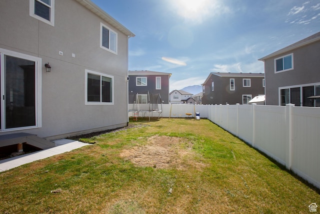 1719 N Pintail Dr Unit 60, Salem, UT 84653 - view of yard with a fenced backyard, a residential view, and a trampoline