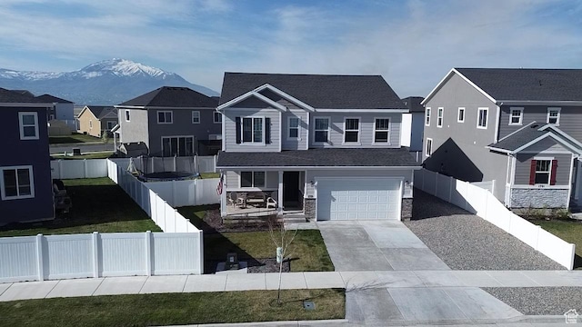 1719 N Pintail Dr Unit 60, Salem, UT 84653 - view of front facade with driveway, stone siding, a mountain view, a porch, and a residential view