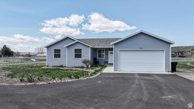 2763 E Read Ln, Preston, ID 83263 - ranch-style home with an attached garage, fence, and aphalt driveway