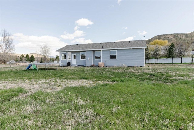 2763 E Read Ln, Preston, ID 83263 - rear view of property with fence, a mountain view, and a trampoline