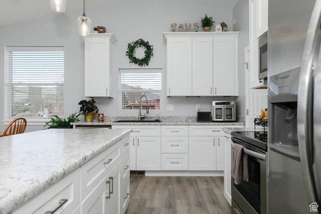 2763 E Read Ln, Preston, ID 83263 - kitchen with white cabinets, lofted ceiling, appliances with stainless steel finishes, and a sink