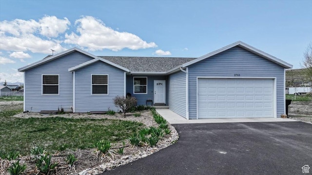 2763 E Read Ln, Preston, ID 83263 - single story home with aphalt driveway, roof with shingles, and a garage