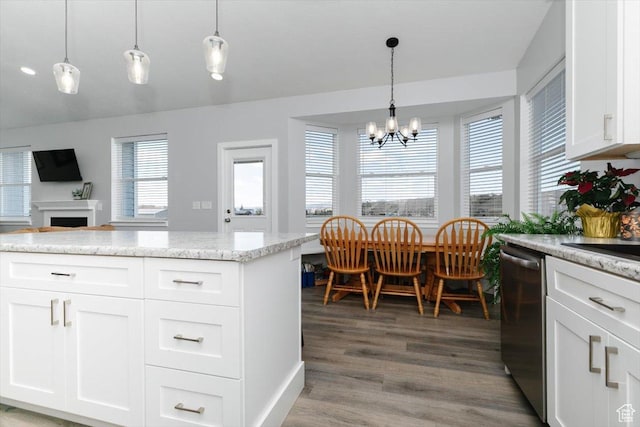 2763 E Read Ln, Preston, ID 83263 - kitchen featuring stainless steel dishwasher, light wood-style floors, an inviting chandelier, a fireplace, and white cabinetry