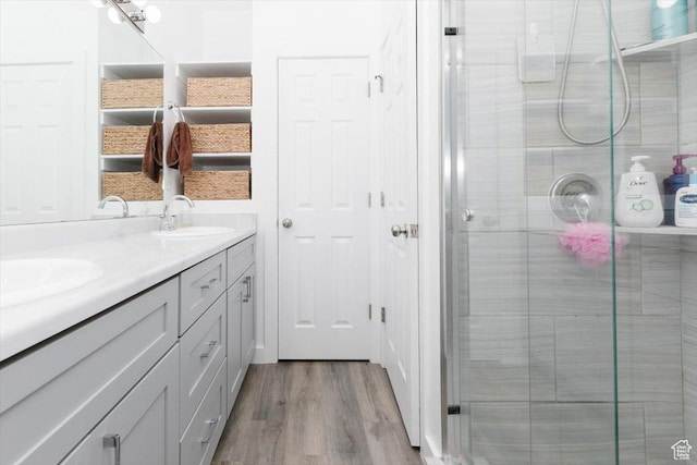 2763 E Read Ln, Preston, ID 83263 - bathroom featuring wood finished floors, a sink, double vanity, and a stall shower