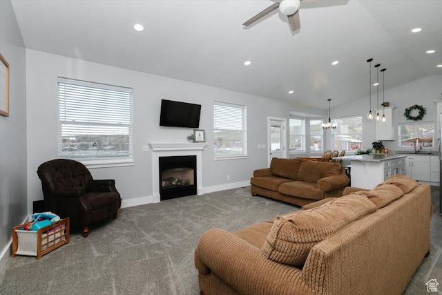 2763 E Read Ln, Preston, ID 83263 - living area featuring vaulted ceiling, ceiling fan with notable chandelier, carpet, a fireplace, and baseboards