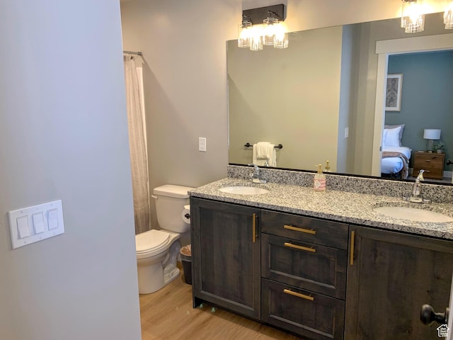 150 W Seasons Ln Unit 4, Garden City, UT 84028 - full bathroom featuring wood finished floors, a sink, double vanity, and toilet