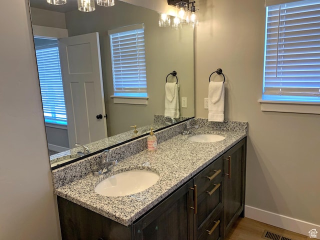 150 W Seasons Ln Unit 4, Garden City, UT 84028 - bathroom featuring baseboards, wood finished floors, a sink, and double vanity